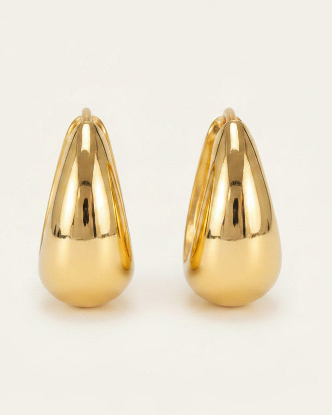 Gold hoop earrings with measurements and material information on a white background