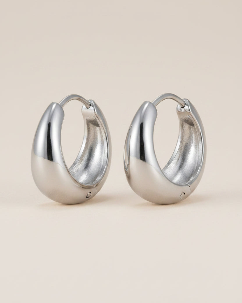 Silver hoop earrings with measurements and material information on a white background