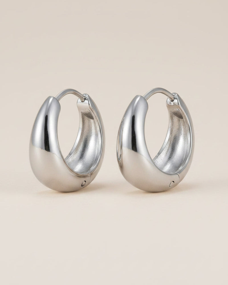 Silver hoop earrings with measurements and material information on a white background