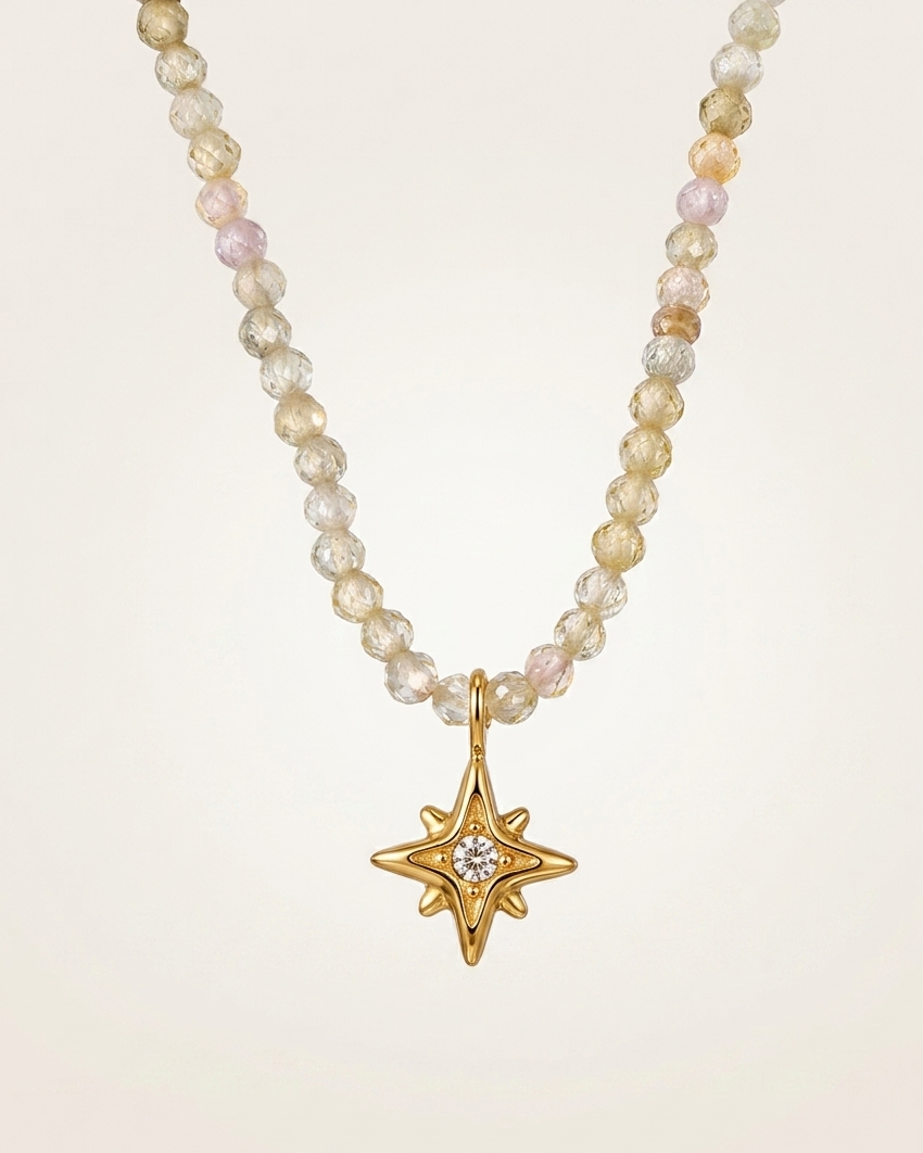 Pearl necklace with a gold star pendant on a beige background