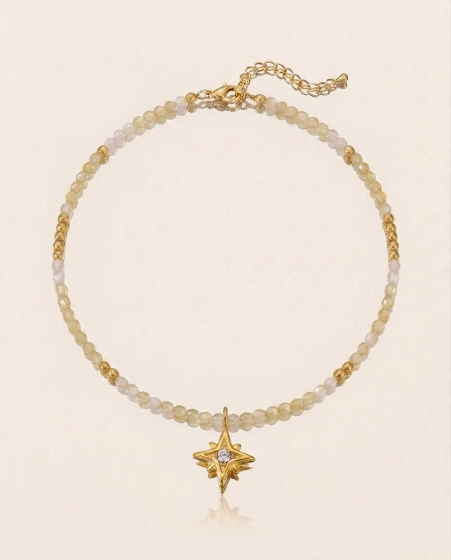 Necklace with star charm and beaded design on a beige background